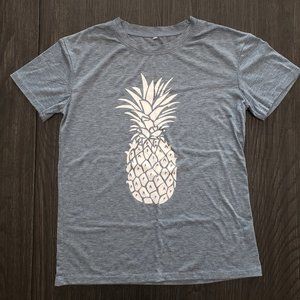 Pineapple white motif girls t-shirt, med/light blue background, size 10-12